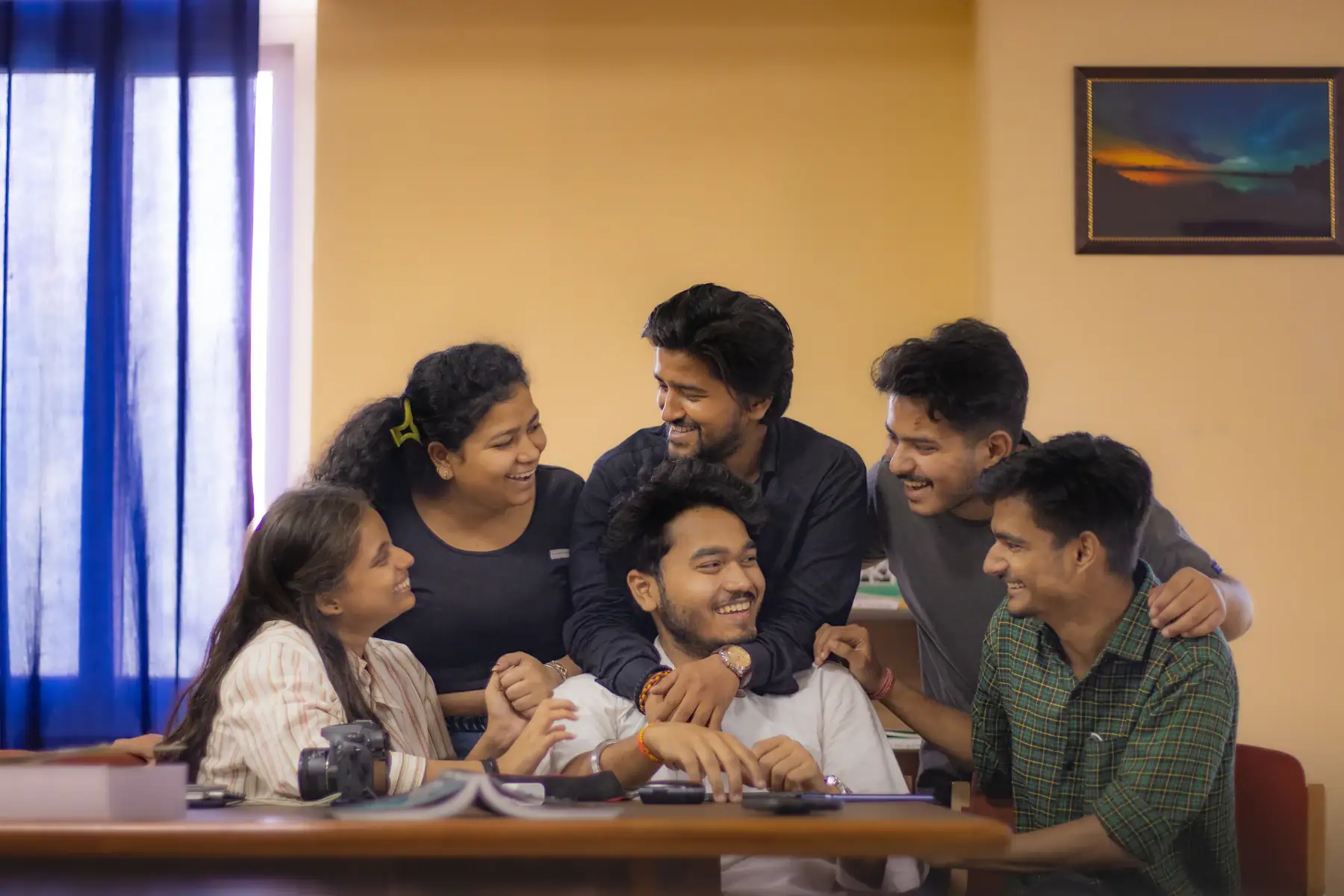 A small team gathered round a table in an office in New Delhi